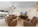 Cozy living room with comfortable leather seating, tile flooring, and natural light from the sliding glass door at 218 Wellington Woods Ave, Deland, FL 32724