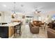 Open-concept living space featuring a kitchen island, tile flooring, and seamless flow between living areas at 218 Wellington Woods Ave, Deland, FL 32724