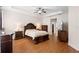 Main bedroom featuring tray ceilings, hardwood floors, and elegant decor at 218 Wellington Woods Ave, Deland, FL 32724