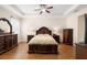 Spacious main bedroom with tray ceilings, hardwood floors, and elegant decor at 218 Wellington Woods Ave, Deland, FL 32724