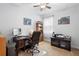 Office space with dark wood desk, computer, bookshelf and printer at 218 Wellington Woods Ave, Deland, FL 32724