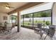 Enclosed patio with brick pavers, ceiling fan and outdoor seating, perfect for enjoying the outdoors at 218 Wellington Woods Ave, Deland, FL 32724