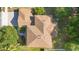 An aerial perspective of the home showcasing its roof design and surrounding mature trees at 227 Blue Crystal Dr, Deland, FL 32720