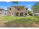 Back exterior featuring two stories with a second story patio and a well maintained lawn at 227 Blue Crystal Dr, Deland, FL 32720