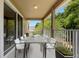 Outdoor balcony with a large table and chairs, perfect for outdoor dining and entertaining at 227 Blue Crystal Dr, Deland, FL 32720