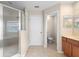 Bathroom featuring tile flooring, cherry cabinets, a glass enclosed shower, and toilet at 227 Blue Crystal Dr, Deland, FL 32720