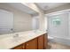 Bright bathroom featuring double sinks with cherry cabinets, tile flooring, and a tub/shower combo at 227 Blue Crystal Dr, Deland, FL 32720