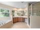 Bright bathroom with a large soaking tub, tiled floors, and dual sink vanity at 227 Blue Crystal Dr, Deland, FL 32720