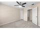 Cozy bedroom featuring neutral walls, carpet flooring, a ceiling fan and closet space at 227 Blue Crystal Dr, Deland, FL 32720