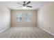 Comfortable bedroom with carpet, neutral paint, a ceiling fan, and two windows at 227 Blue Crystal Dr, Deland, FL 32720