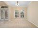 Bright dining area with large windows, neutral walls, and seamless transition to other rooms at 227 Blue Crystal Dr, Deland, FL 32720