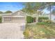 Charming two-story home with a three car garage, landscaped yard, and manicured hedges at 227 Blue Crystal Dr, Deland, FL 32720