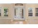 Welcoming foyer with bright double doors, tile flooring, and windows offering natural light at 227 Blue Crystal Dr, Deland, FL 32720