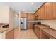 Well-lit kitchen with stainless steel appliances, wooden cabinetry, and neutral countertops at 227 Blue Crystal Dr, Deland, FL 32720