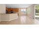 Kitchen area featuring dark wood cabinetry, tiled floors, bar counter, and natural light at 227 Blue Crystal Dr, Deland, FL 32720