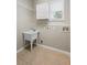 Functional laundry room with a utility sink, cabinet storage, and a window at 227 Blue Crystal Dr, Deland, FL 32720