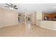 Spacious living room with open floor plan, tile flooring, and a view into the kitchen at 227 Blue Crystal Dr, Deland, FL 32720