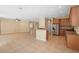 Open floor plan with tiled floors, natural light, and kitchen bar at 227 Blue Crystal Dr, Deland, FL 32720