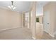 Open-concept living room with neutral colors, decorative columns, and lots of natural light at 227 Blue Crystal Dr, Deland, FL 32720
