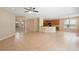 Bright, open-plan living room featuring tile flooring and seamless flow to kitchen and dining areas at 227 Blue Crystal Dr, Deland, FL 32720