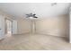 Spacious main bedroom with neutral carpet, paint, and ceiling fan; plus dual access doors at 227 Blue Crystal Dr, Deland, FL 32720