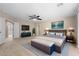 Spacious main bedroom with a ceiling fan, a large bed and a sitting area at 227 Blue Crystal Dr, Deland, FL 32720