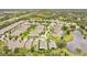 An aerial view of a residential community featuring manicured lawns, tree-lined streets, and tranquil ponds at 241 Old Moss Cir, Deland, FL 32724