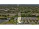 Aerial view of a residential neighborhood, featuring well-maintained homes, lush greenery, and a tranquil pond at 241 Old Moss Cir, Deland, FL 32724