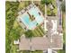 Aerial view showcases a large swimming pool and clubhouse, surrounded by palm trees and well-maintained landscaping at 241 Old Moss Cir, Deland, FL 32724