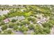 Panoramic aerial view of community amenities, including tennis courts, a clubhouse, and a pool, all surrounded by trees at 241 Old Moss Cir, Deland, FL 32724