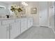 Bathroom featuring double sinks, a large mirror, white cabinetry and a glassed shower at 241 Old Moss Cir, Deland, FL 32724