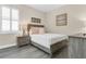 This neutral bedroom features a queen sized bed, side table, and natural light at 241 Old Moss Cir, Deland, FL 32724