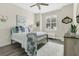 This bedroom features a queen sized bed, overhead fan, and natural light at 241 Old Moss Cir, Deland, FL 32724