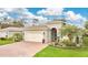 Charming single-story home featuring a well-manicured lawn, lush landscaping, and an attached two-car garage at 241 Old Moss Cir, Deland, FL 32724