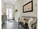 Bright foyer showcasing a tray ceiling, dark floors, bench with pillows, and attractive decor at 241 Old Moss Cir, Deland, FL 32724