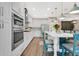 Modern kitchen with white cabinets, center island, stainless steel appliances and pendant lights at 241 Old Moss Cir, Deland, FL 32724