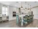 Bright, updated kitchen featuring white cabinets, quartz countertops, island seating, and stainless appliances at 241 Old Moss Cir, Deland, FL 32724