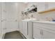 Bright laundry room with modern appliances, overhead storage, and a convenient utility sink at 241 Old Moss Cir, Deland, FL 32724