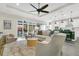 Bright living area features a ceiling fan, comfortable seating, and sliding glass doors at 241 Old Moss Cir, Deland, FL 32724