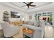 Cozy living room with a ceiling fan, natural light, and neutral-toned furniture at 241 Old Moss Cir, Deland, FL 32724