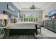 This main bedroom features a dark wood bedframe, tray ceilings, and natural light at 241 Old Moss Cir, Deland, FL 32724