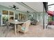 Spacious screened patio offering an ideal outdoor living space with multiple seating areas at 241 Old Moss Cir, Deland, FL 32724