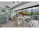 Relaxing screened patio with comfortable seating, dining area, and ceiling fans at 241 Old Moss Cir, Deland, FL 32724