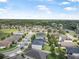 Aerial view of a suburban neighborhood featuring well-maintained homes, lush landscaping and tree-lined streets at 2412 Regency Park Dr, Deland, FL 32724