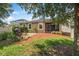 Spacious backyard has manicured lawn, a fire pit, and tranquil spot for outdoor enjoyment at 2412 Regency Park Dr, Deland, FL 32724