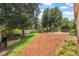 Large backyard with a fire pit area and mature trees, providing a serene outdoor space at 2412 Regency Park Dr, Deland, FL 32724
