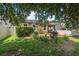 Inviting backyard has lush greenery, a white fence, and a relaxing fire pit area at 2412 Regency Park Dr, Deland, FL 32724