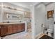 Well-lit bathroom with a double vanity, tile shower, and modern fixtures at 2412 Regency Park Dr, Deland, FL 32724