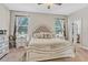 Cozy bedroom with neutral tones, a decorative headboard, and ample natural light at 2412 Regency Park Dr, Deland, FL 32724
