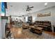 Open-concept living room with a fireplace and seamless flow to kitchen and dining areas at 2412 Regency Park Dr, Deland, FL 32724